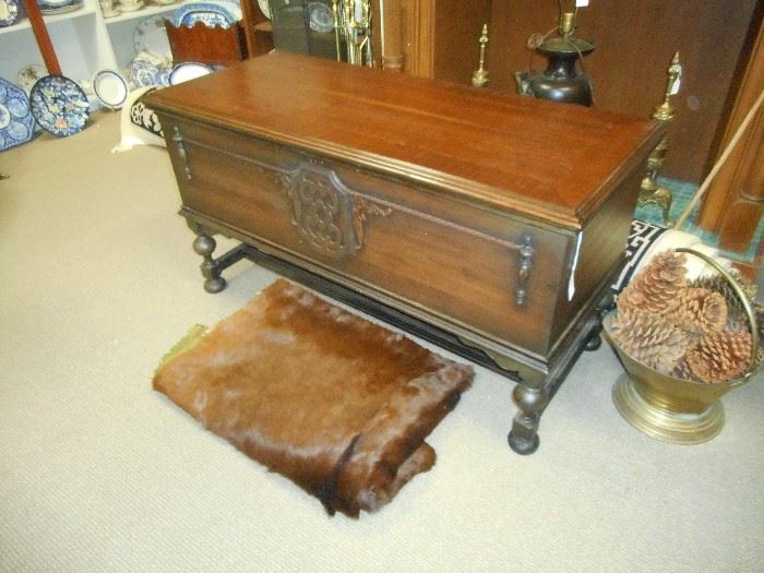 Lane Hope Chest /cedar lined in beautiful condition. and Vintage Sleight Blanket (animal hide).  Brass scuttle  with oversized pine cones