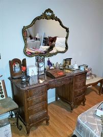 Dresser, mirror, vanity seats, perfume bottles