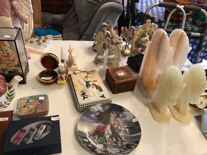 Lots of native American collector plates. Hand carved horse head book ends from Arizona or New Mexico. Vintage travel clocks. 