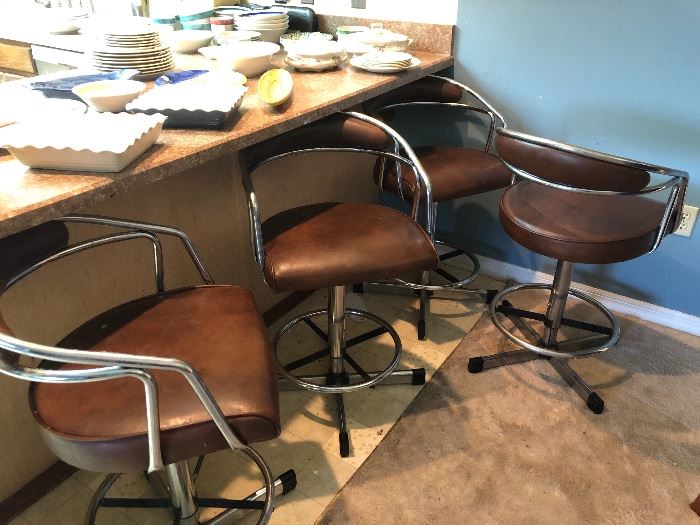 Four leather and chrome bar stools