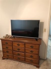 Maple dresser, has mirror.  Flat screen tv. 43”