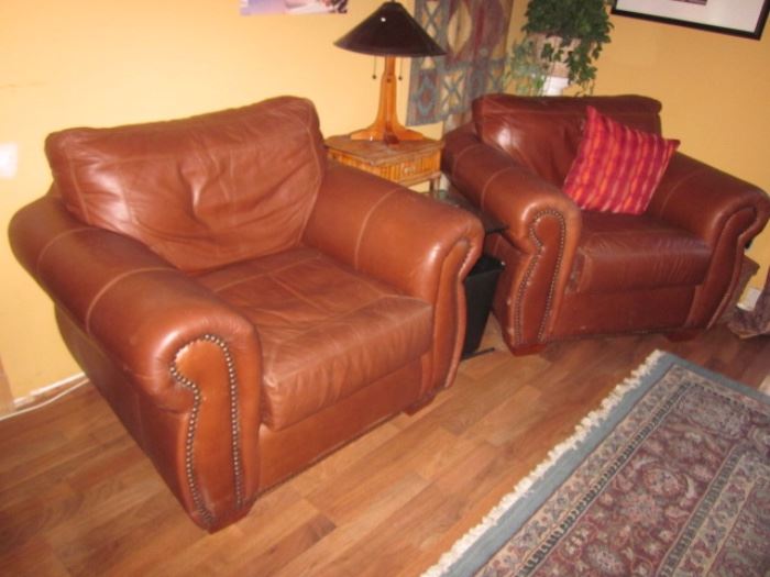 PAIR NATUZZI LEATHER TUFTED ARM CHAIRS