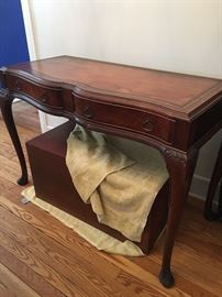 Mahogany and leather top serpentine front console.