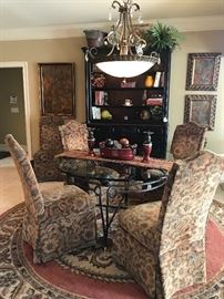 Glass top and iron table with brass feet and brass medallion accents, 5 custom upholstered parson chairs with nail heads