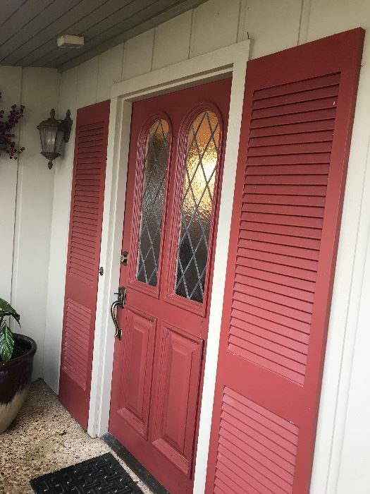 Front door with matching shutters , and leaded glass panels. 