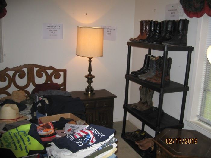 Mens boots, night stand and lots of men's clothes.