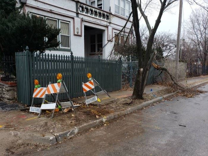 Green painted wooden fencing on front side of buil ...