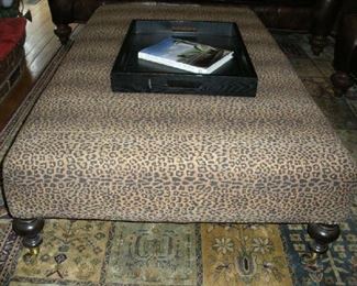 Family Room:  The custom made leopard fabric ottoman is on casters and measures 61" x 36" x 16" tall.