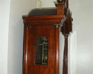 Foyer:   The side of the clock bonnet has a small glass door in to which you can see the clock's inner workings.