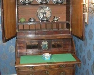 Living Room:  The antique secretary is now open to reveal the interior.   Notice the two adjustable upper shelves over nine "pigeon holes."  Three narrow shallow drawers separate the upper section from the lower section [which has a total of five small drawers on each side of a small middle door].  The fall front writing surface is above three drawers with bracket feet supporting this magnificent piece.