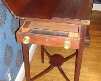 Living Room: This antique desk's top flips open, as shown with one side now flipped.  The drawer has a pencil ledge.  There are actually two knobs on each side of the desk, but only one drawer.