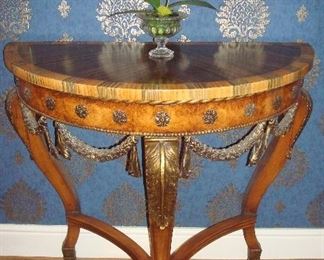 Living Room:  The classic demi-lune table has three legs, brass embellishments, and a unique painted top (see next photo).  It measures 34" wide x 17" deep x 31-l/2" tall.