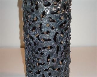 Collectibles-in Kitchen:  Trench Art:  A vintage (1974) 10" tall artillery shell case was turned in to a piece of art by Brother Mel (Vianney Catholic High School).  