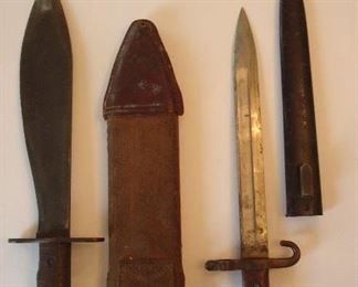 Collectibles in Kitchen:  The knife on the left has a canvas sheath.  It is a World War I Marine Knife, inscribed 1918, and made by the Plumb Company in Philadelphia.  The canvas sheath was made by the Brauer Brothers and still has its "water drip" intact.     The knife on the right is a World War II  trench knife and has a black metal sheath.  It was made by the V&N Company of  Hungary.
