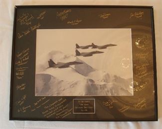 Collectibles in Kitchen:  Photo is associated with the  "54th Fighter Squadron Fightin' Leopards.. Once a Leopard Always a Leopard... 1940-1996."  The mat has signatures of the surviving members of the 54th Fighting Squadron.