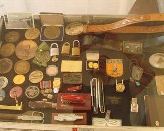 Collectibles-in Kitchen:  Numerous medals, tokens, knives and collectibles are to the left of a variety of "Conquistadores Del Cielo" ("Conquerors of the Sky") historical items.  The CDC is the most prestigious club in aviation, consisting of just the 
top executives.  These items belonged to Sanford McDonnell.
