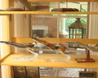 Collectibles in Kitchen:  Models shown:                      top shelf are two proto-types:  two drop models/wind tunnel/model of aircraft designed to fly like both an aircraft and a helicopter; Phantom II-Royal Navy;  F4H - camouflage plane was St. Louis built and sold to Iraq prior to 1979--recently, it has been used to fight ISIS; YF-17;  Phantom II - Navy; Phantom II - Marines; and a  F4-H (VOODOO).