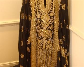 Dining Room:  This richly embellished black and gold gown as quite a story!  Years ago, McDonnell Douglas sold some planes to the former ruler King  Fahd Bin Abdul Aziz Al Saud of Saudi Arabia (now deceased).  When the King's son Prince Mohammad Bin Fahd Bin Abdul Aziz Al Saud visited with the McDonnells, he gave this gown to Pris McDonnell as a gift of his appreciation for hosting him.  The next photo shows one of the "sleeves" extended.
