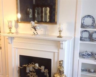 Living Room: At the fireplace are:  a classic mirror adorned with garlands and "x" ribbons (38" wide x 31" tall); a pair of WATERFORD crystal/brass candleholders; Vienna Austria figurine of Lipizzaner Stallion and rider; a decorative brass/mesh fireplace screen; and a brass woman with hoop skirt fireplace broom cover.