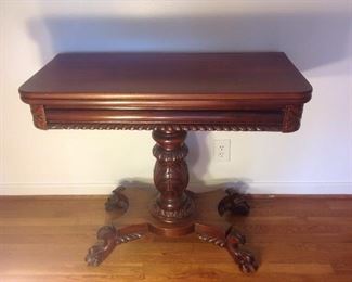 Landing-Second Floor:  This antique (circa 1890-1910) Victorian flip-top/mahogany game table is shown with the top folded.  Notice the elegantly carved details on the pedestal and legs with claw feet. In this position it measures 36" wide x 17" deep x 30" tall.  The top flips open and can be displayed with the leaf against the wall OR it can be turned to create a game table.  The game pieces can be stored in the table cavity.  Another photo follows.