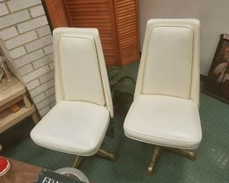 (2) Mid century modern cream vinyl swivel chairs