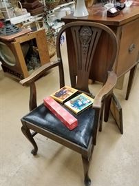 Antique ornate chair with black padded vinyl seat