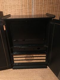 Mid-century Asian TV cabinet with newer Samsung flat screen TV installed