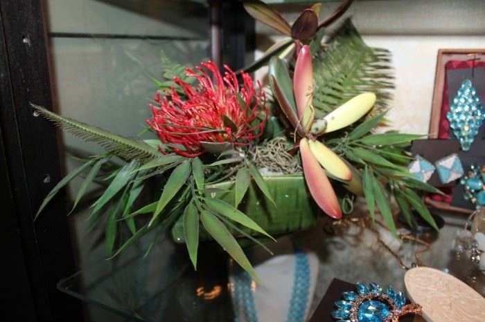 Tropical floral arrangement in a vintage planter