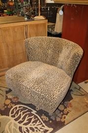 Pair of 1950s swivel chairs professionally upholstered in a soft leopard print fabric. Legs have been black lacquered.
