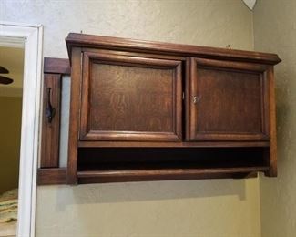 Antique hanging cabinet with hooks and shelf