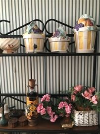 Canister set, bakers rack and floral arrangements.