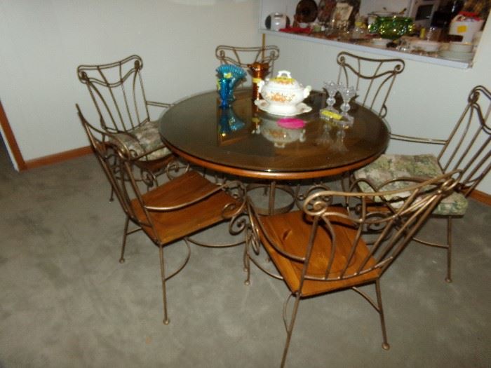 Wood and Metal Dining Room Set. Wood Top Metal Framed Table with a Glass protector. Six Chairs, very nice.