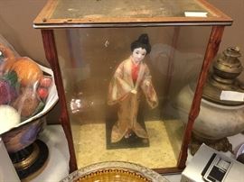 Very old doll in glass case