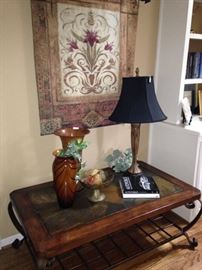 Another good-looking coffee table, tapestry, lamp, and decor