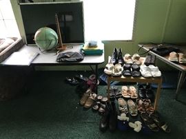A variety of women’s shoes and a vintage globe.