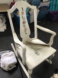 A white wooden rocking chair.