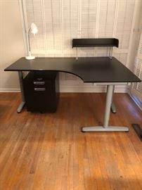 Ikea wooden desk with file cart on wheels (top drawer locks), paper stand, cord organizer, and desk lamp
