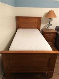 Tempurpedic twin mattress, matching hand-carved wooden bed frame. nightstand, and box spring; airplane lamp, hand-forged