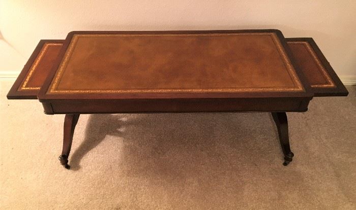 MARVELOUS ANTIQUE LEATHER TOP COFFEE TABLE WITH SLIDE OUTS, ON CASTORS