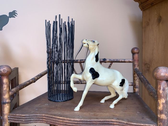 Plastic horse and metal candle stick holder