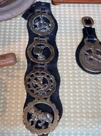  Set of four metal horse riding metals on leather strap 