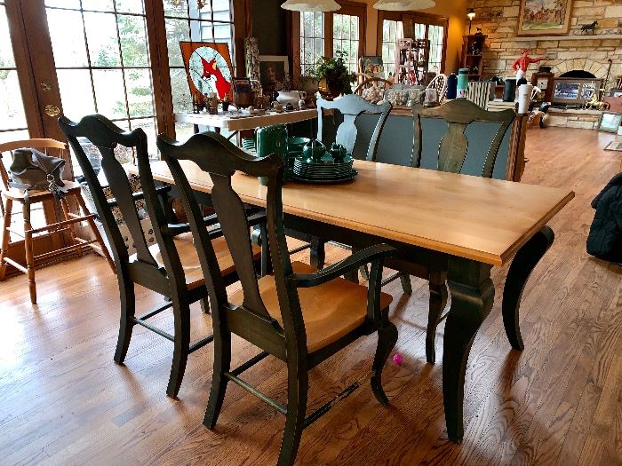  Long, thin kitchen table with green painted legs and green painted matching chairs. 