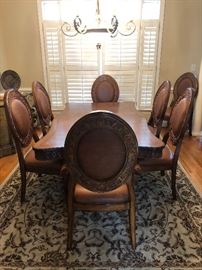  Beautiful dining room table with 8 leather padded chairs and additional leaf