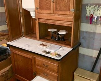 oak Hoosier (?) cupboard with porcelain top, roll door, flour sifter & bread drawer. 