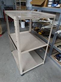 Metal media cart on wheels.