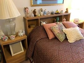Bookshelf headboard with lots of angel figurines