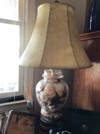 Glass lamp filled with treasures from the sea