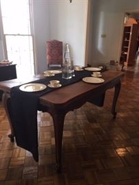 Carved dining table that opens to 90 inches.