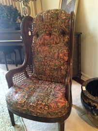 One of two matching upholstered chairs perfect for the fireside.