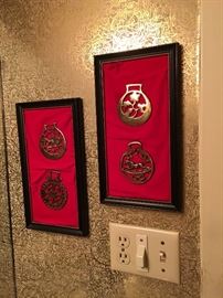black and red mcm wall art with mounted horse brasses